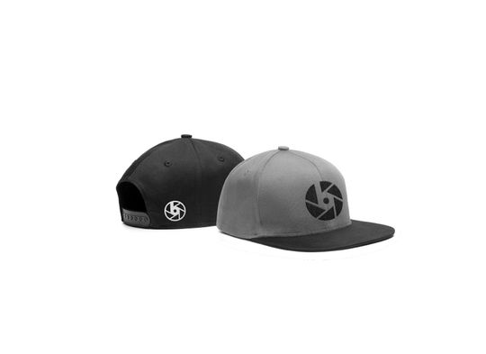 Two snapback mockups with the logomark